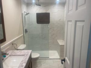 a bathroom with a shower and a toilet and a sink at Peaceful in Evergreen +8 photos