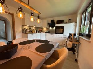 a kitchen with a table and chairs in a room at Allgäu Moments Oberstaufen in Oberstaufen