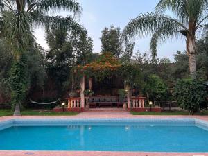 una piscina di fronte a una casa di Villa DALIA Route Ourika en Exclusivité a El Jemʼa Ghemat