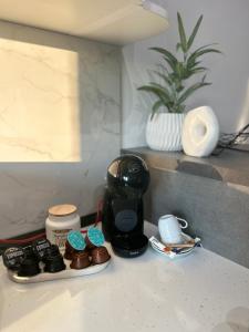 a counter with a coffee maker and cups on it at CASAMORE Rentals in Braşov +12 photos