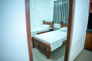 Postel nebo postele na pokoji v ubytování Backpackers GuestHouse Trincomalee