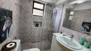 a bathroom with a sink and a shower at BLISS BOHO HOUSE in Sintra +17 photos