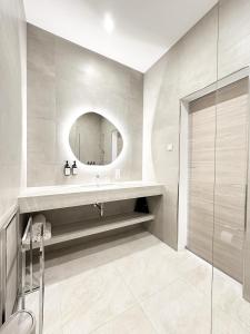 a bathroom with a sink and a mirror at The Treasury Hotel in Neuss +64 photos