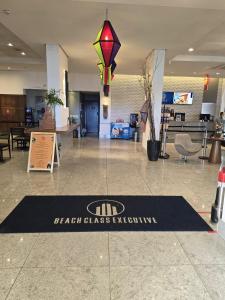 a health glass activation sign on the floor of a lobby at Beach Class Executive in Recife +27 photos