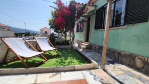 two lawn chairs sitting outside of a house at BLISS BOHO HOUSE in Sintra