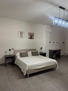 a bedroom with a large bed and a desk at B&B centro baia domizia in Baia Domizia