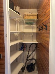 a walk in closet with white shelves at Cozy apartment in Arâches-la-Frasse