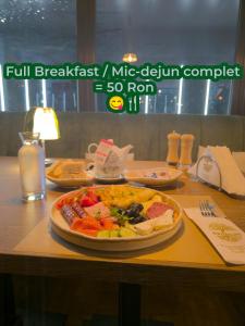 a table with a plate of food on it at Uni88 Apart Hotel in Bucharest +264 photos