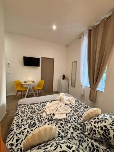 a bedroom with a bed with a robe on it at La Perle in Narbonne