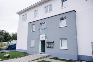 a white house with a door at Luxus Penthouse Apartment Europa-Park in Lahr
