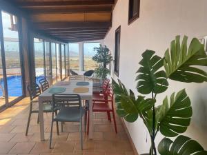 a dining room with a table and chairs and plants at Casa Estela in Villaverde