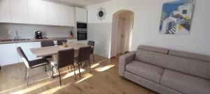 a kitchen and living room with a table and a couch at Villa Bianca in Privlaka