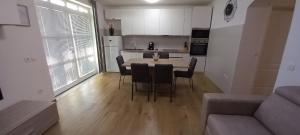 a kitchen and living room with a table and chairs at Villa Bianca in Privlaka +15 photos