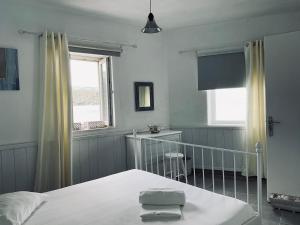 a bedroom with a bed and a window at Romantic Stone Villa in Samos +9 photos