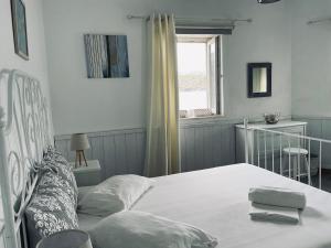 a bedroom with a bed and a window at Romantic Stone Villa in Samos
