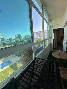 a room with large windows and a view of the city at Appartement malabata in Tangier +4 photos