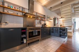a large kitchen with a large stove and cabinets at De Grote Sluis in Harlingen