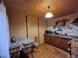 a kitchen with a table and a kitchen with a table and chairs at Садиба Орисин Явір Orysyn Yavir in Svityazʼ
