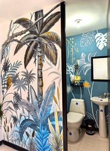 a bathroom with a palm tree mural on the wall at Gaia512A in Montenegro