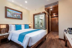 Voodi või voodid majutusasutuse Aarya Hotel and Spa toas