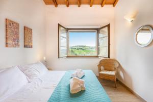a bedroom with a bed and a window and a chair at Villa Paradiso - Piscina, Parcheggio e Privacy in Pian D'artino +68 photos