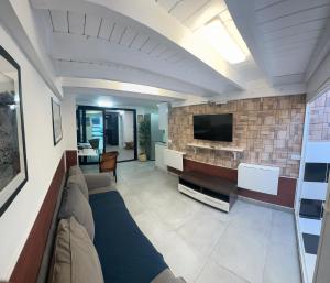 a living room with a couch and a flat screen tv at Villa Luna in Corralejo