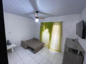 a living room with a couch and a window at Cantinho de São Chico in São Francisco do Sul