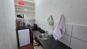 a small kitchen with a sink and a counter at Boabab at Greenway Woods in White River