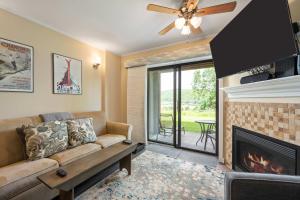 a living room with a couch and a fireplace at Cozy 1 Bedroom Condo Holiday Valley in Ellicottville +17 photos