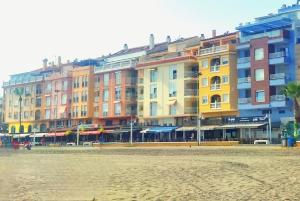 a row of colorful buildings on a beach at Hikari&Sineida Home in Rincón de la Victoria