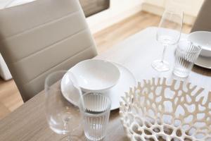 a table with white plates and glasses on it at Hillview House in Belfast