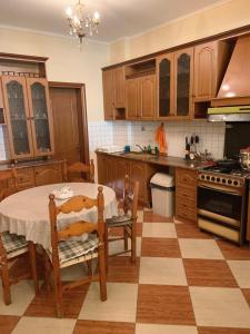 a kitchen with a table and chairs and a stove at Family Comfort and Central Apartment in Vlora in Vlorë