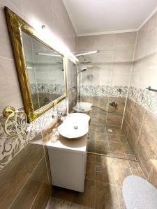 a bathroom with a sink and a shower and a mirror at Vila Sedef Costinești in Costinesti +25 photos