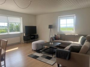 a living room with a couch and a table at Feriehus Broløkken Rudkøbing in Rudkøbing