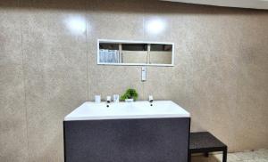 a bathroom with a sink and a mirror on a wall at HST Casa Sol Mérida in Mérida +25 photos