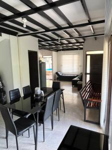 a living room with tables and chairs and a couch at Finca de Majo in Mocoa