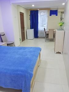 a hospital room with a blue blanket on a bed at Уют in Kutaisi