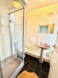 a bathroom with a sink and a toilet and a shower at The Avon in Blackpool