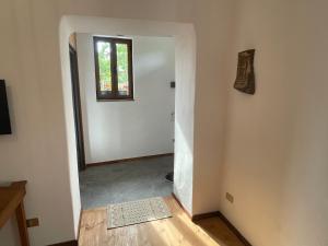 a hallway with a door leading into a room with a window at Iris House - Casa indipendente a Berat in Berat
