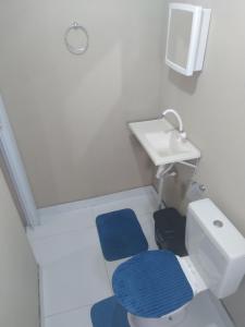a small bathroom with a toilet and a sink at Vista do vale in Triunfo