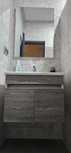 a bathroom with a sink and a mirror at Amouage résidence 5 in Mirleft +39 photos