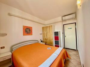 a bedroom with an orange bed in a room at Casa Blu di Pomposa Vista Mare in Lido di Pomposa