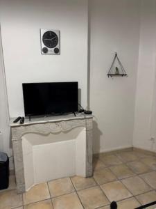 a flat screen tv sitting on top of a white wall at un lit double dans une chambre dans un appartement de 3 chambres en colocation à proximité du centre ville in Toulon
