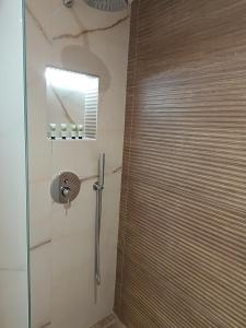 a shower with a glass door in a bathroom at GeoMar Luxury Apartments in Skala Marion