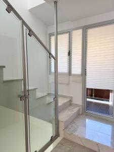 a staircase in a house with glass doors andwindows at Triplex con vistas al mar junto al campo de golf de Calanova in Mijas Costa