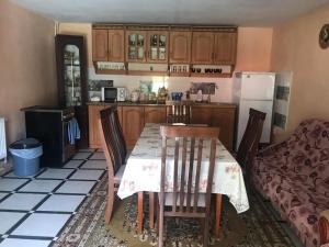 a kitchen with a table and chairs in a room at Перлина in Pilipets