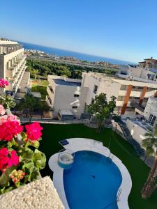 a view of a resort with a swimming pool and buildings at Triplex con vistas al mar junto al campo de golf de Calanova in Mijas Costa