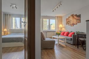 a bedroom and a living room with a bed and a couch at Vorto Apartament 4 - Warszawa Centrum in Warsaw
