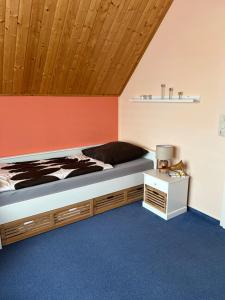 una camera da letto con un letto e un soffitto in legno di Ferienhaus Leuchtturmblick Hafendorf Rheinsberg a Rheinsberg