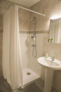 a bathroom with a shower curtain and a sink at Marina Blue, Las Caletillas in Candelaria